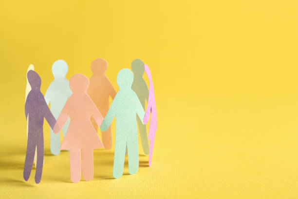 istock Many different paper human figures standing in circle on yellow background, space for text. Diversity and inclusion concept 1477276973