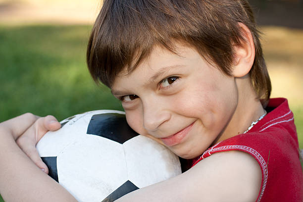 istock boy with soccer ball 147727719