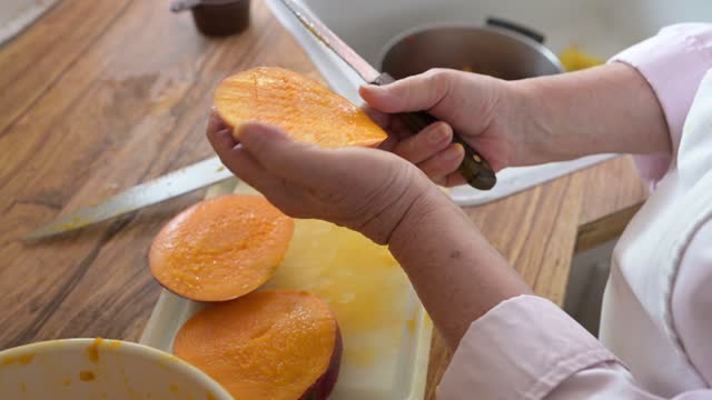 Florida Senior Woman Cutting Mangos on Kitchen Counter
