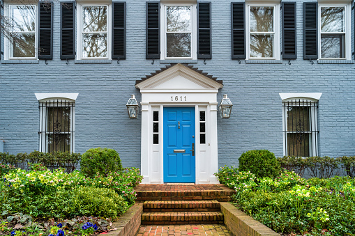 Door and facade of a traditional house in Georgetown district, Washington DC, USA on a cloudy day.