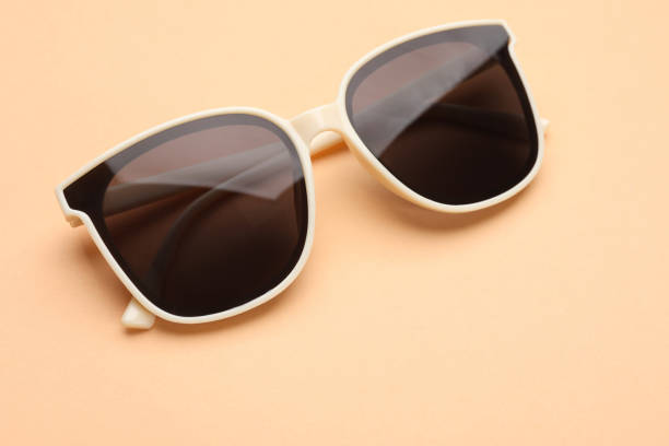 istock New stylish elegant sunglasses on beige background, closeup 1477280788