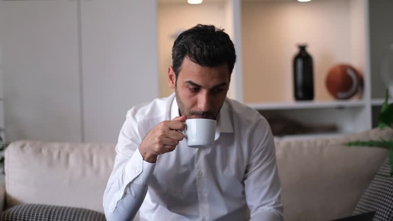 Young businessman relaxing on comfortable with cup of coffee.