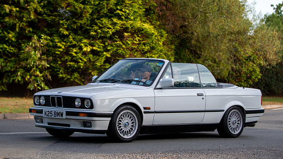 Whittlebury,Northants,UK - August 28th 2022. 1992 2494cc BMW 325i car driving on an English country road