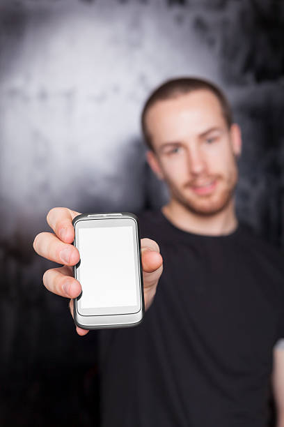 istock Men showing screen of cell phone, focus on device 147729147