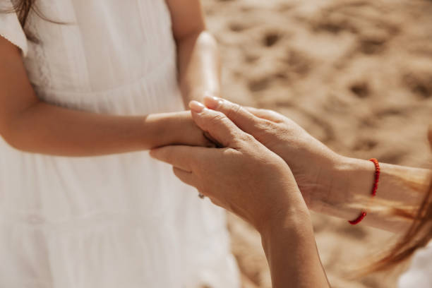 istock Mom holding hands of child 1477291620