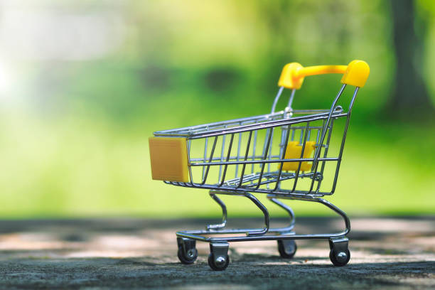 istock Shopping cart and green blur background 1477294103