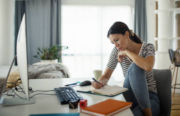 istock Young woman learning at home. 1477298968