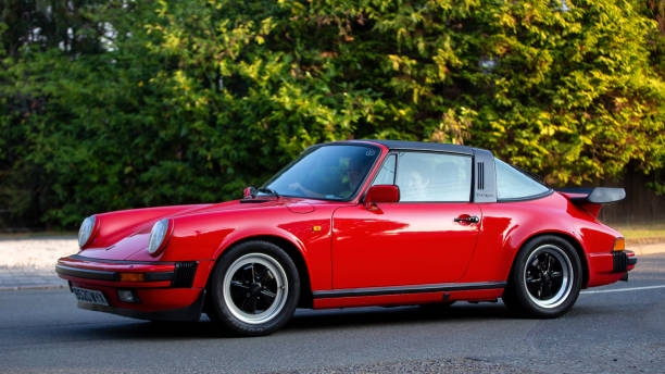 Whittlebury,Northants,UK - August 27th 2022. 1984 Porsche 911 Carrera Targa car travelling on an English country road