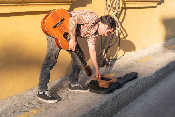istock Man collecting money after performance on street 1477299977