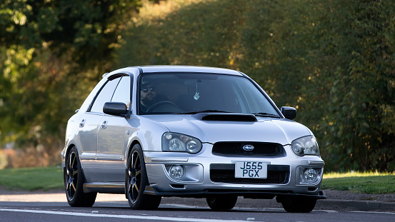 Bicester,Oxon,UK - Oct 9th 2022. 2003 Subaru Impreza classic car driving on an English country road
