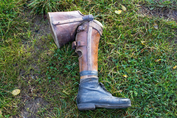 old prosthetic leg laying on grass stock photo