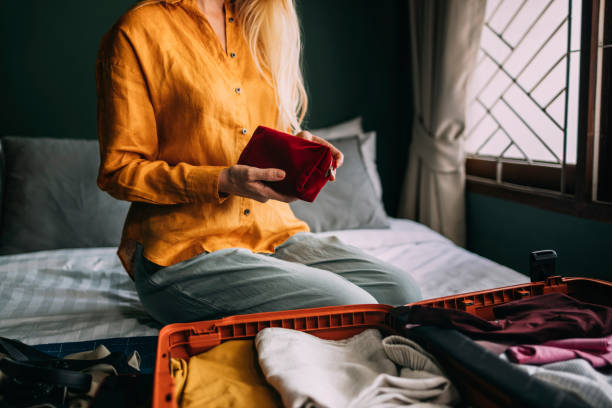 istock An Unrecognizable Beautiful Blonde Woman Packing Her Suitcase For A Trip 1477307907