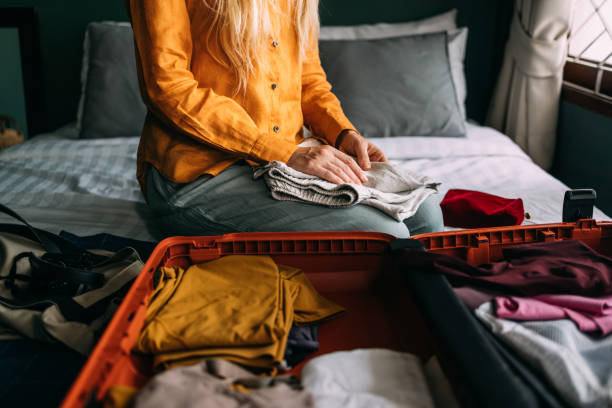 istock An Unrecognizable Beautiful Blonde Woman Packing Her Suitcase For A Trip 1477307926
