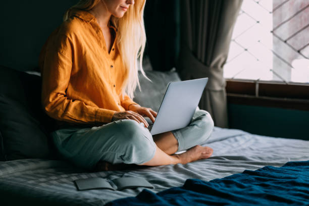 istock An Unrecognizable Beautiful Blonde Businesswoman Working From Home Using Her Computer While Sitting On Her Cozy Bed In The Bedroom 1477307962