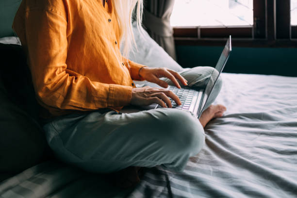 istock An Unrecognizable Beautiful Blonde Businesswoman Working From Home Using Her Computer While Sitting On Her Cozy Bed In The Bedroom 1477307980