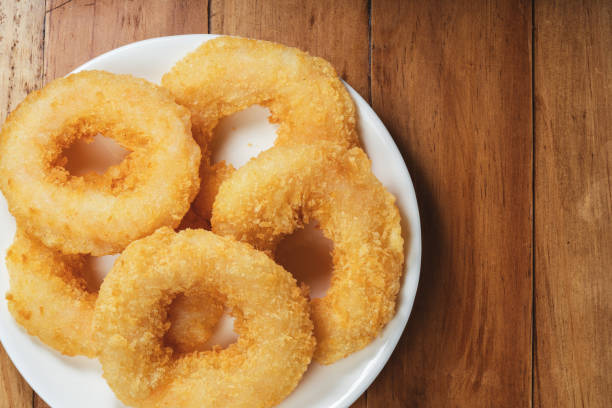 istock Fried shrimp donut in white plate on wooden table. 1477309595