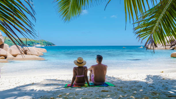 istock Praslin Seychelles tropical island with withe beaches and palm trees, couple men and women mid age on vacation at the Seychelles visiting the tropical beach of Anse Lazio Praslin Seychelles drone view 1477311710