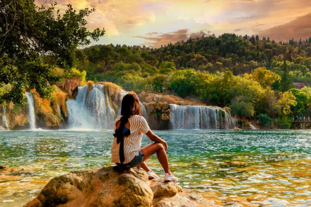Photo of KRK waterfalls, woman watching waterfall Croatia Krk national park