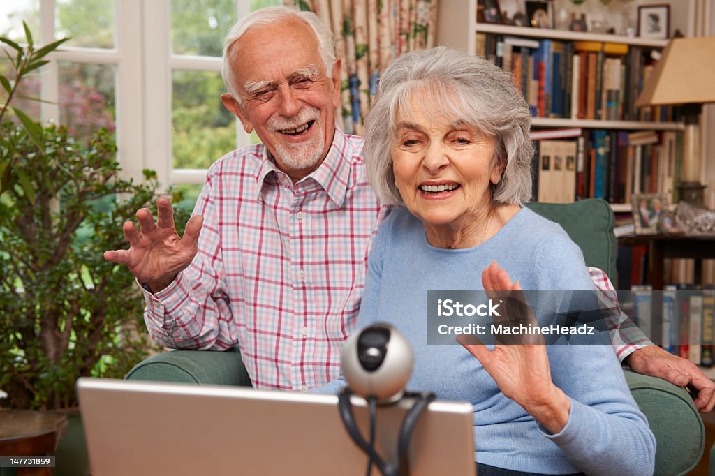 Couple Senior à l'aide d'un ordinateur portable et Webcam pour parler avec votre famille - Photo de Troisième âge libre de droits