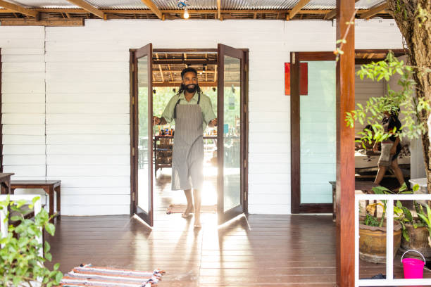 istock Handsome male opening cafe 1477319561