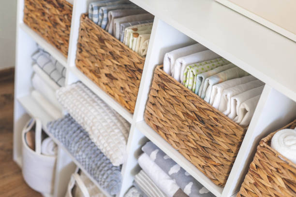 istock Neatly folded linen cupboard shelves storage at eco friendly straw basket placed closet organizer 1477320583