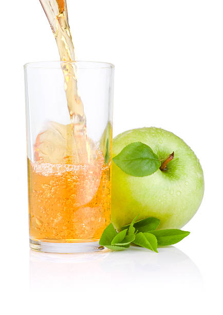 istock Pouring apple juice into a glass, green apples with leaf 147734118