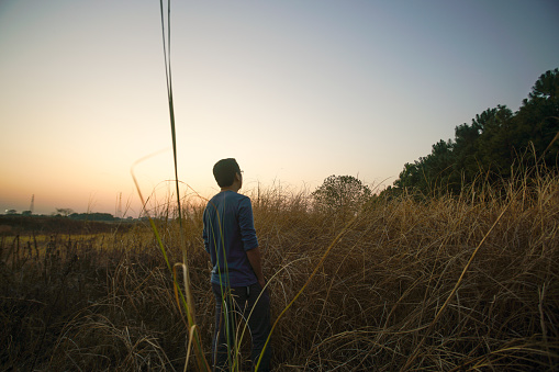 one man alone in the grassland near dawn