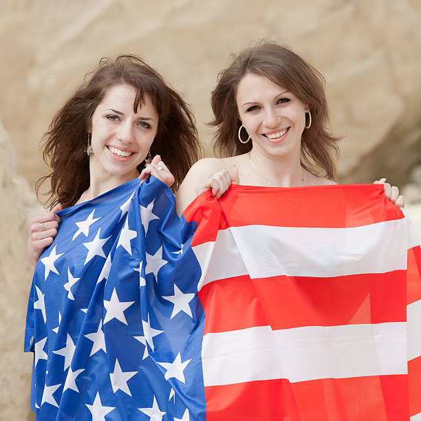 istock Two sisters with flag of USA on open air 147734754