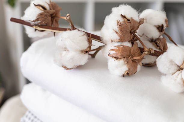 istock Cotton branch with pile of folded bed sheets and blankets 1477349743