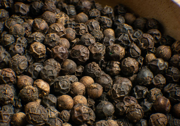 istock The black pepper corn on wood table for food concept 1477358321