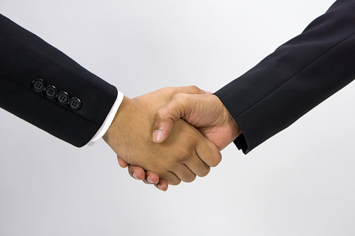 Closeup business partners shaking hands, celebrating business success. Front View