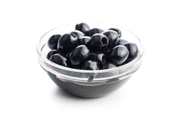istock Pitted black olives in bowl isolated on white background. 1477366629