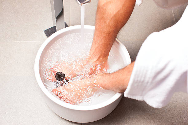 man having hydrotherapy water footbath stock photo