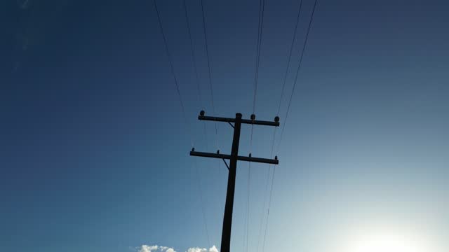 Telephone Pole Silhouetted By Late Afternoon Sun