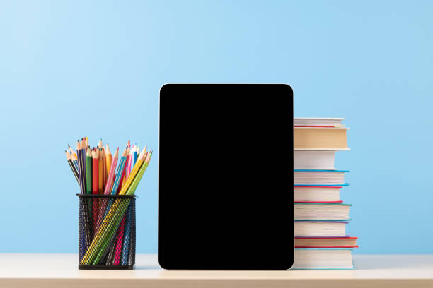 istock Tablet with colorful pencils and stack of books 1477375944