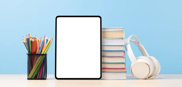 istock Tablet with colorful pencils and stack of books 1477376495