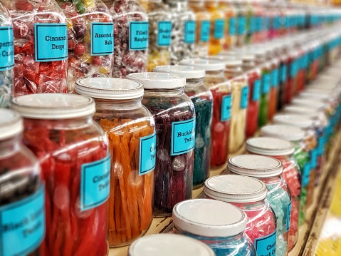 Old fashioned New England candy store has more candy choices than I ever even knew was possible! This large collection of glass jars filled with delicious house-made confections line the walls atop wooden shelves for eager customers, young and old.