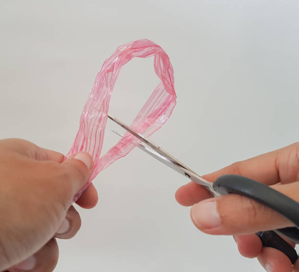 istock people's hands are cutting raffia rope on white isolated background 1477386277