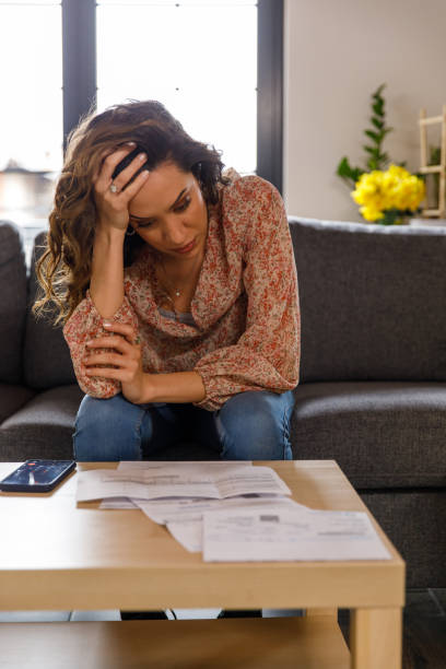 istock Woman struggling with finances when sorting out her bills 1477388558