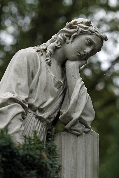 istock Statue mourning woman in a cemetery 147739048