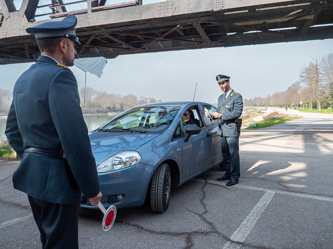 Braga, Portugal - May 23, 2018: policeman checks and writes a traffic ticket on a car in the city center on a spring day