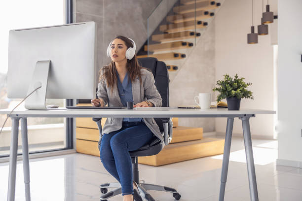 istock Female entrepreneur with computer working in modern office 1477394243