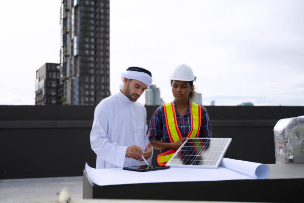 Business man work with engineer at rooftop. stock photo