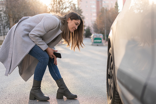Woman Having Trouble With Her Broken Down Car Flat Tire