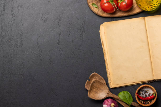 istock Top-down view of a kitchen table with ingredients, utensils, and an open cookbook 1477400069
