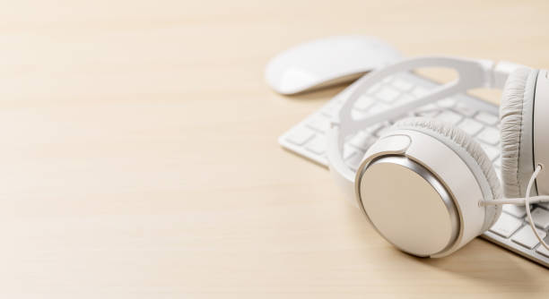 istock Workspace with keyboard, mouse, and headphones on desk 1477400623