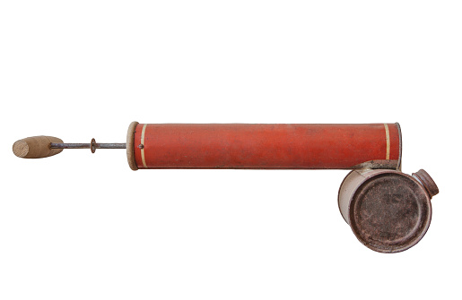 Old rusty manual spray pump for insecticides. Isolated over white background