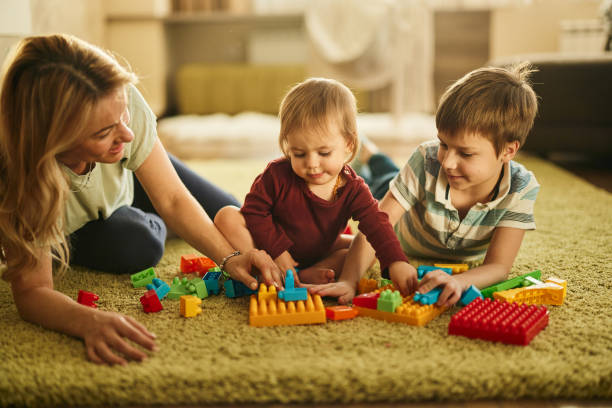 istock Mother playing whit her kids at home 1477407222