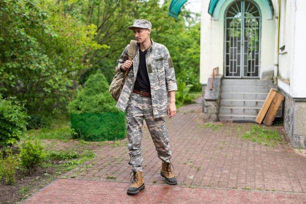 istock Young caucasian man wearing camouflage army uniform 1477423914