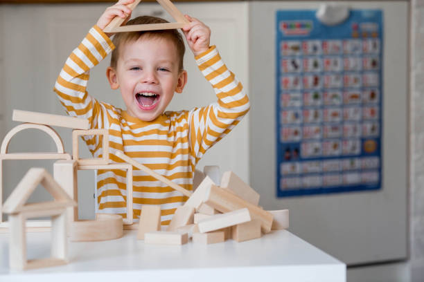 istock A little boy of 3 years old is playing a developing logistics constructor. Children's wooden toys. Montessori for child development. 1477424430